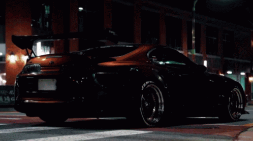 Purple Sports Car Parked at Night
