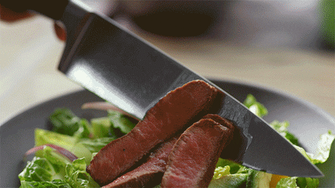 Putting A Sliced Of Meat On A Bowl Of Salad GIF