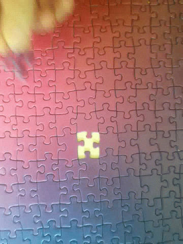 Putting Last Piece Of Colorful Jigsaw Puzzle GIF