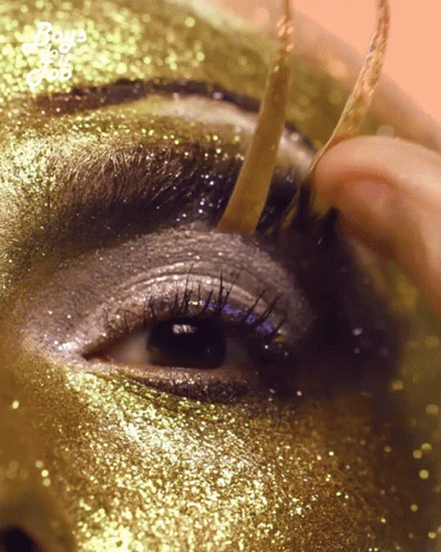 Putting On Gold Fake Eyelashes GIF