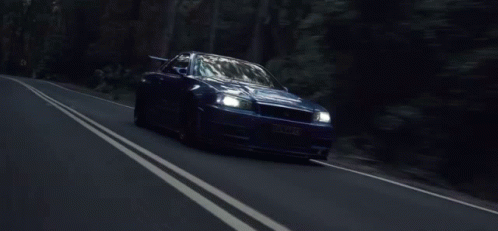 Nissan Skyline R34 Driving Along Highway GIF