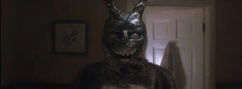 Rabbit Mask Person in Dark Room