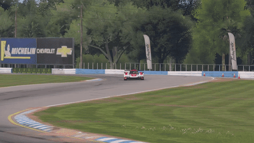 Race Car Around Curve With Michelin Sign