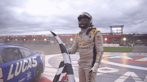 Race Car Driver Holding Checkered Flag Lucas Car