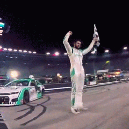 Race Car Driver Holding Trophy and Flag