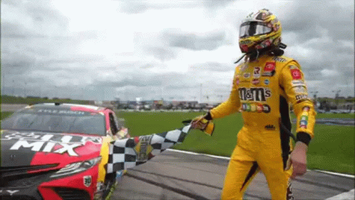 Race Car Driver Waving Checkered Flag at M&M's Car