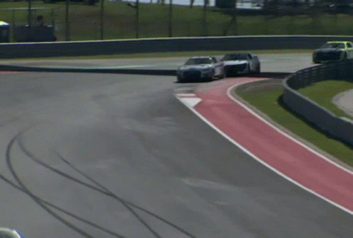 Race Car Driving Down Track