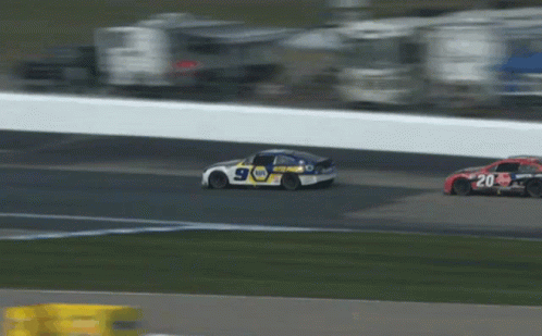 Race Car Driving Down Track With Cars Behind