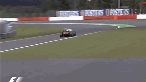 Race Car Going Around Curve With Bridgestone Sign