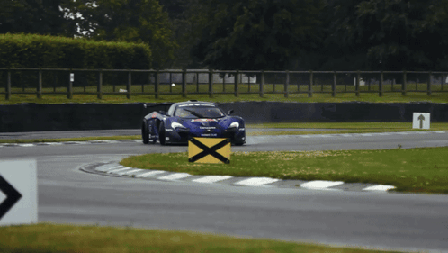 Race Car Going Around Curve with Yellow X