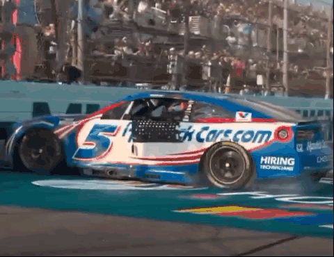 Race Car Number 5 Driving Down Track