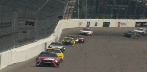 Race Cars on Track With Vote Tobacco Sign