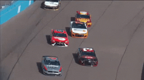 Race Cars Racing on Track With Auto