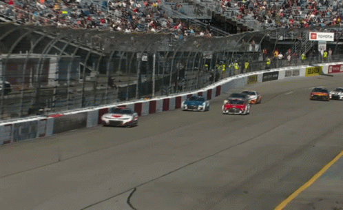 Race Cars Racing Past Yellow DHL Sign
