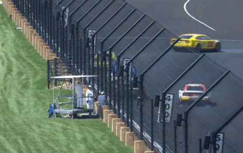 Race Track With Fence And Sign Saying 409 GIF