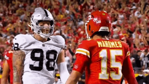 Raiders and Chiefs Football Players Standing