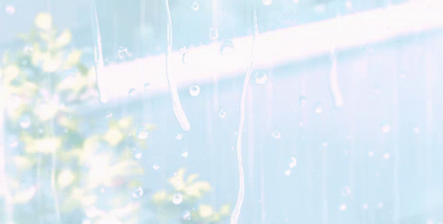 Rain Drops On A Window With The Sun Shining Through It GIF