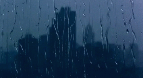 Rain Drops on Window With City Skyline