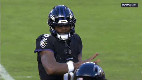 Ravens Football Player Wearing Helmet and Jersey