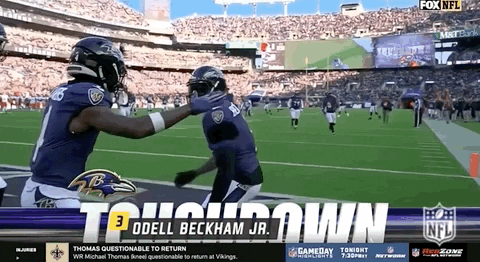 Ravens Players Hugging on Football Field
