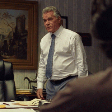 Ray Liotta Penetrating Gaze Sitting In Office GIF