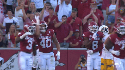 Razorbacks Player Putting Hand Up Whiles Running GIF