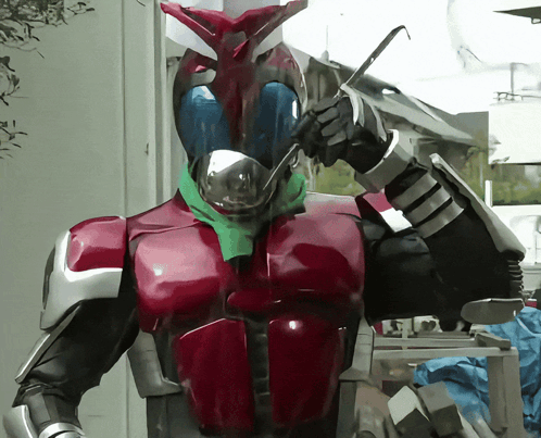 Red and Black Robot With Green Scarf