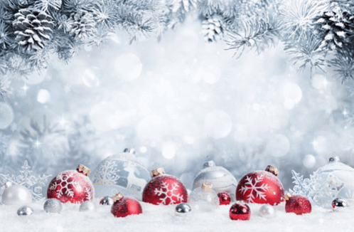 Red And Silver Christmas Ornaments In The Snow With Pine Cones In The Background GIF