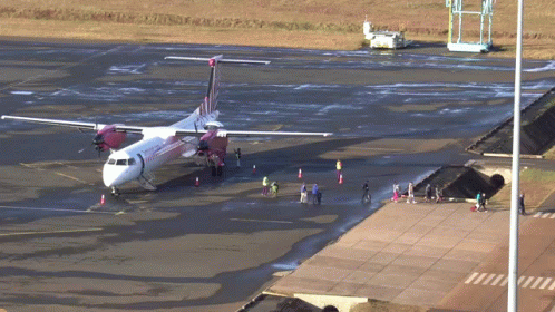 Red and White Airplane on Tarmac