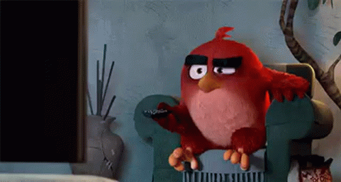 Red Angry Bird on Chair Holding Remote