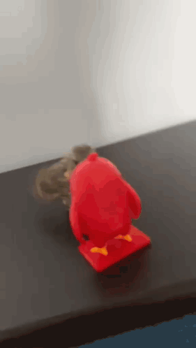 Red Angry Bird Toy Next to Mouse