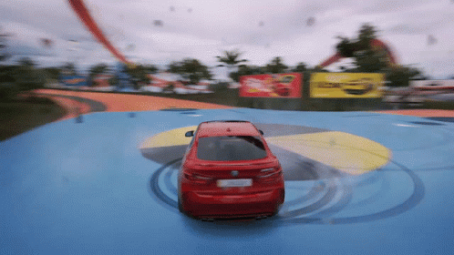 Red BMW Driving on Blue Track