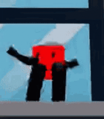 Red Box With Arms and Legs in Front of Window