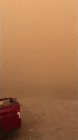 Red Car Barely Visible In Dust Storm GIF