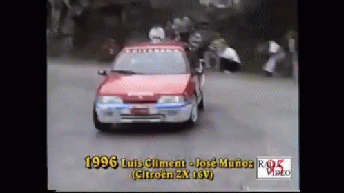 Red Car Driving Down Road With 1996 GIF