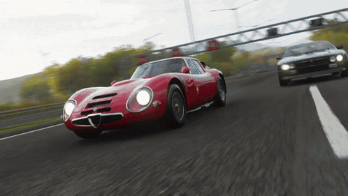 Red Car Driving on Highway with White Car Behind