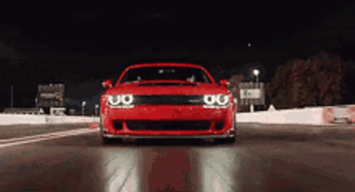 Red Car Driving on Track at Night