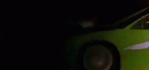 Red Car Driving Past White Car on Road