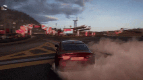 Red Car Driving With Tire Smoke