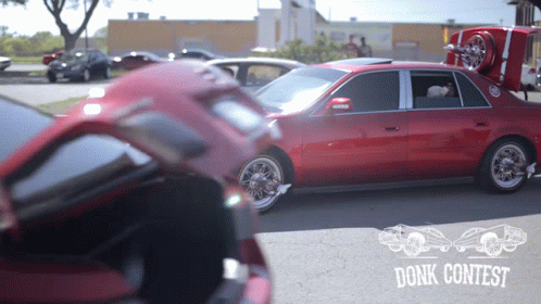 Red Car Parked In Front Of Donk Contest Sign