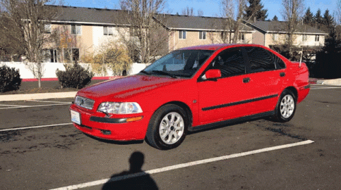 Red Car Parked Outside Apartment Building GIF
