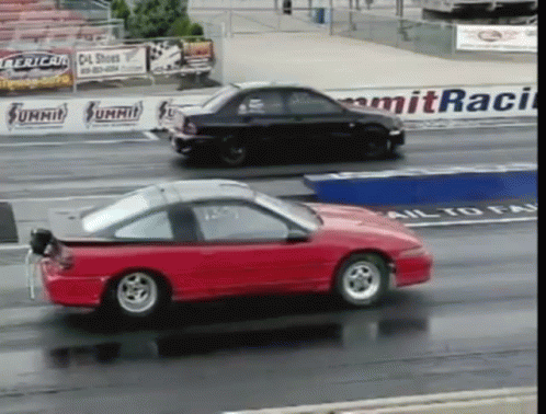 Red Car Passing Black Car on Summit Race Track
