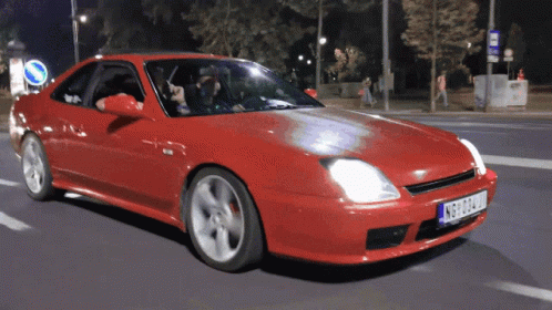 Red Car with Plate nbg324u Driving