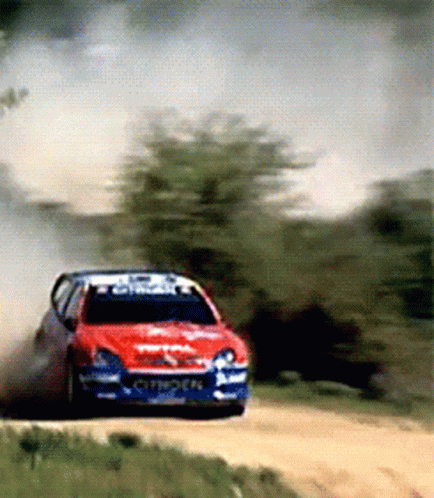 Red Citroen Driving on Dirt Road