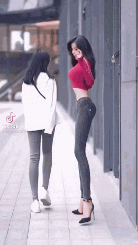 Red Crop Top Woman Beside Another