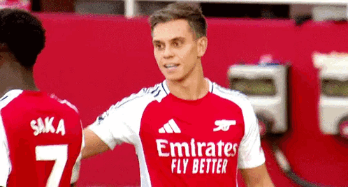 Red Emirates Fly Better Jersey Player with Teammate