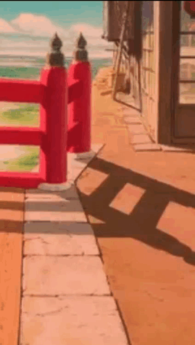 Red Fence on Sidewalk Beside Building