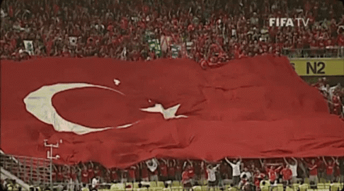 Red Flag With White C and Star in Front of FIFA TV N2 Sign