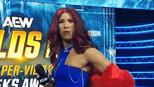 Red Hair Woman in Blue Dress Holding Microphone