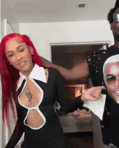 Red Hair Woman Next To Man In Sunglasses And Black Dress GIF